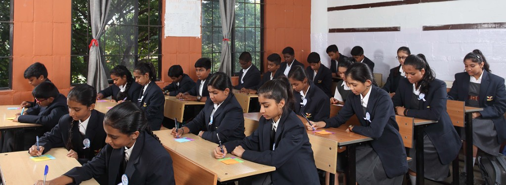 High school students writing in class at Lawrence High School