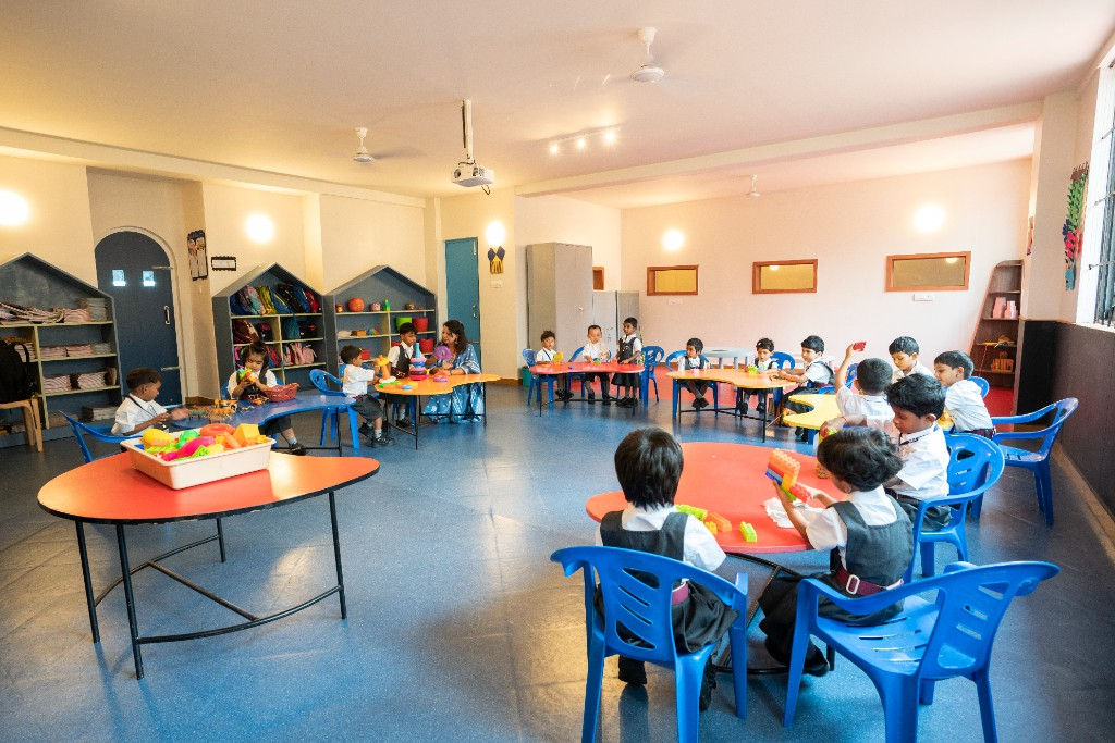 Kindergarten children learning together in a Lawrence High School classroom