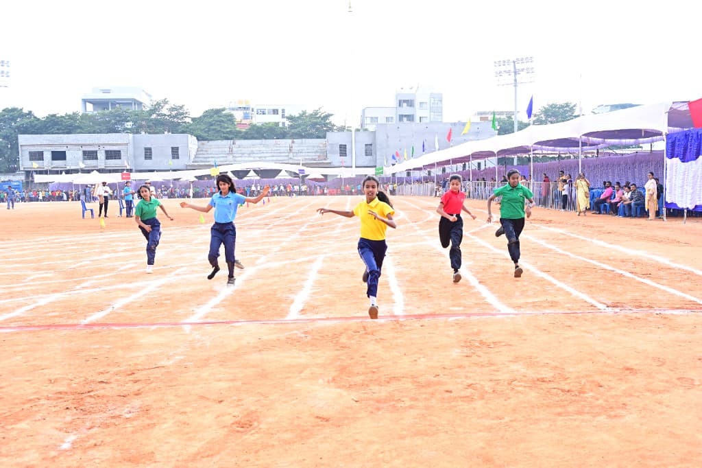High school students sprinting on sports day at Lawrence High School