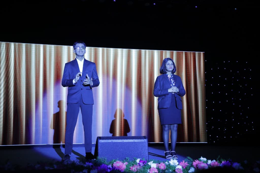 High school students speaking on stage at Lawrence High School