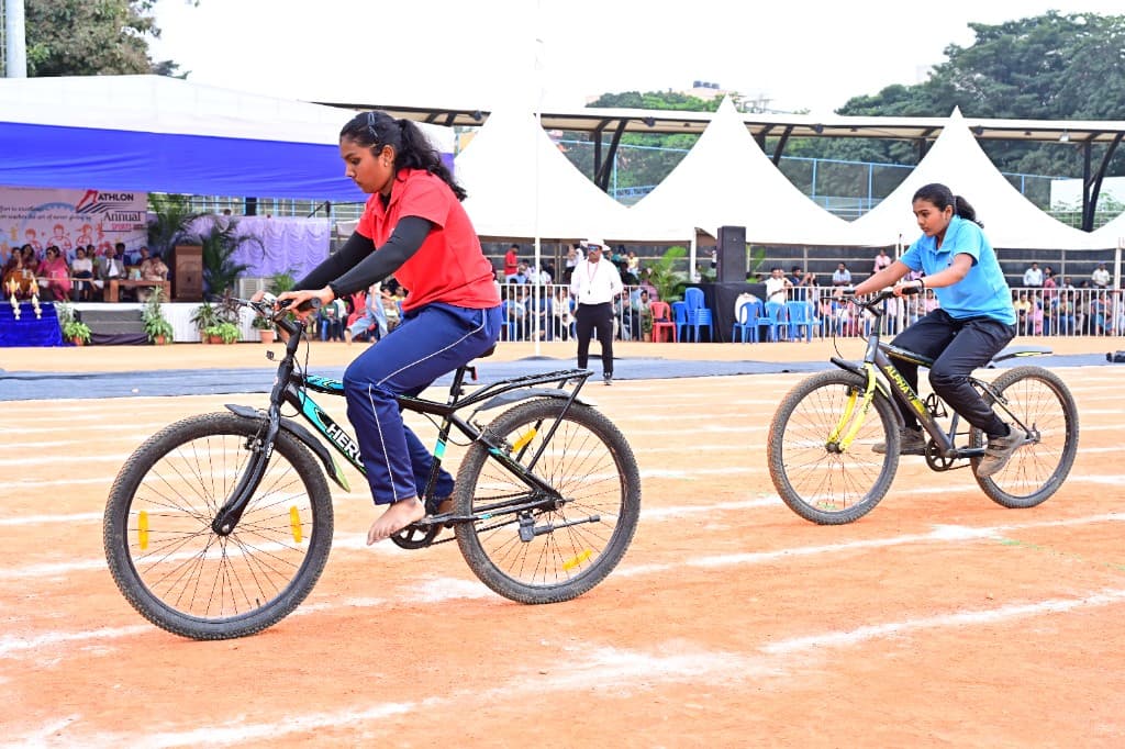 High school students cycling during an athletics event at Lawrence High School