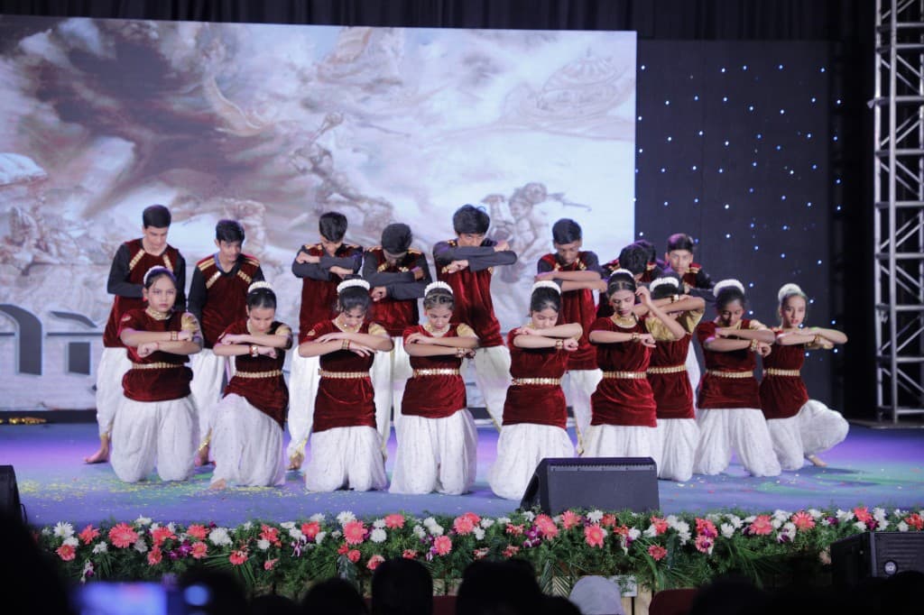 High school students performing a traditional group dance at Lawrence High School