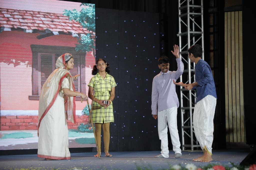 High school students acting in a cultural play at Lawrence High School