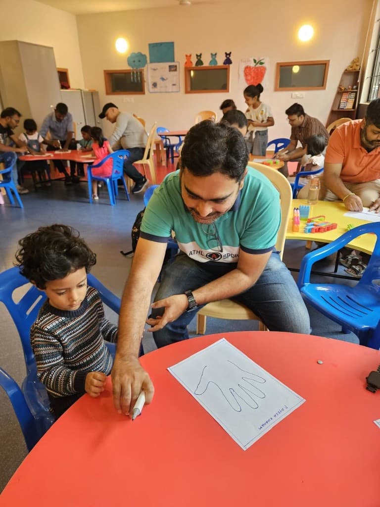 A parent drawing with a kindergarten child at Lawrence High School