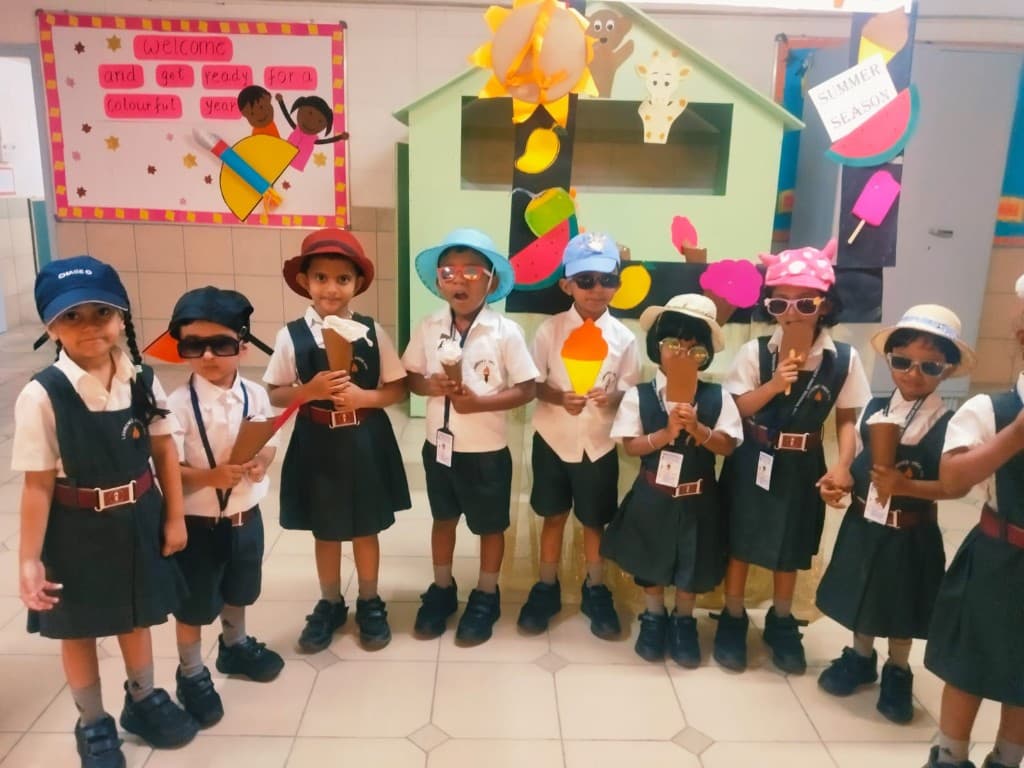 Kindergarten children in hats celebrating summer at Lawrence High School