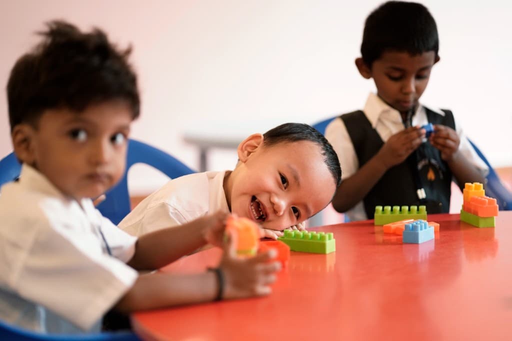 Kindergarten children playing with building blocks