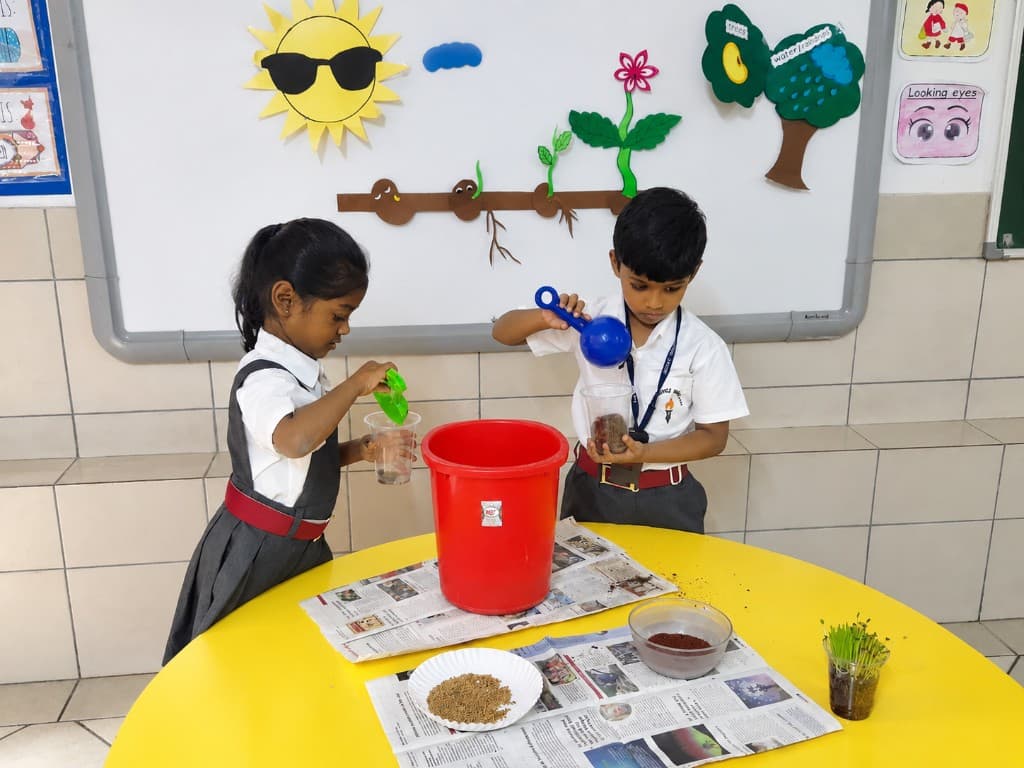 Kindergarten children planting and exploring growth at Lawrence High School