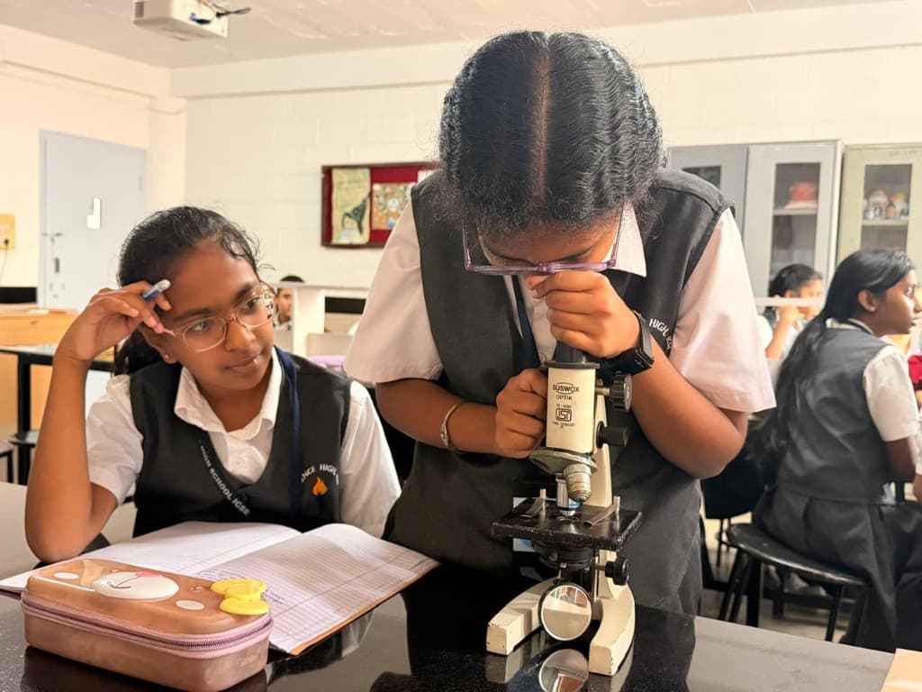 Middle school students using a microscope in the science lab