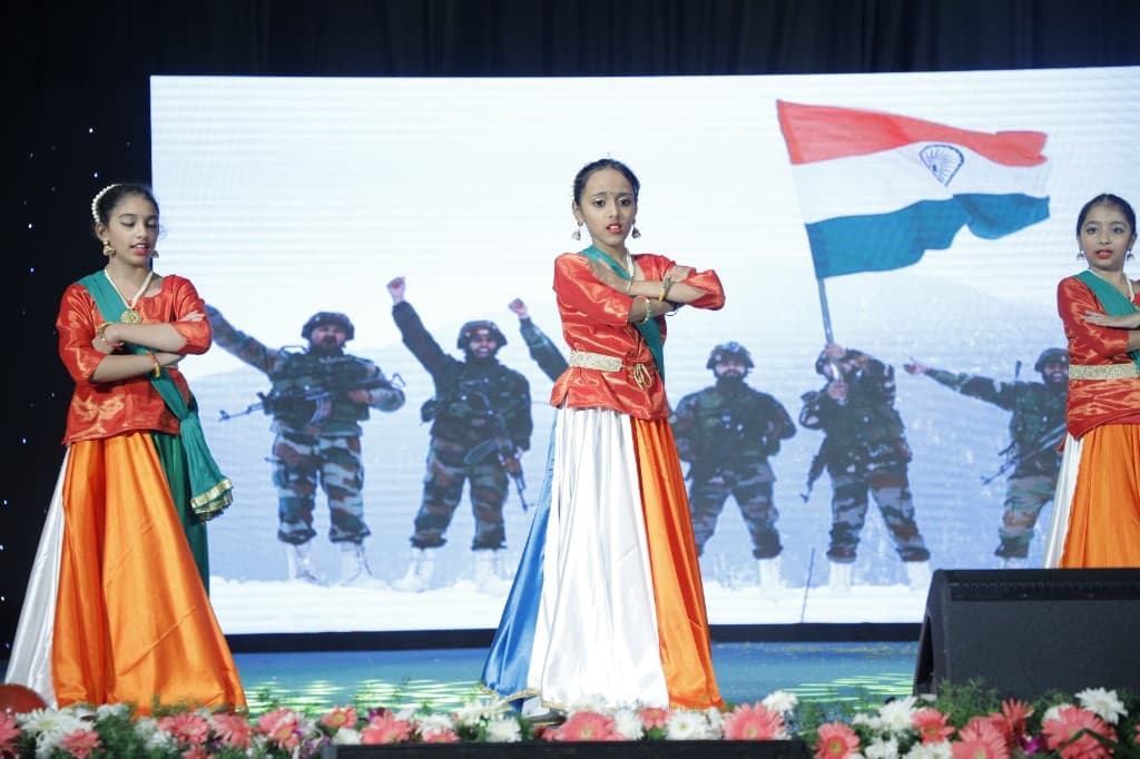 Middle school students performing a patriotic dance on stage