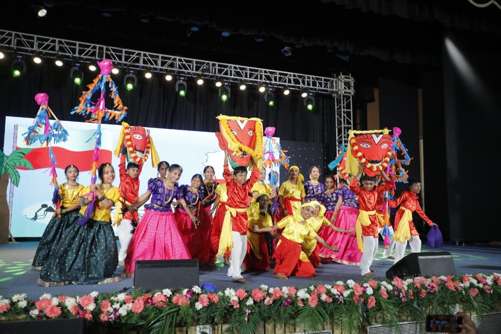 Middle school students performing a folk dance with masks on stage