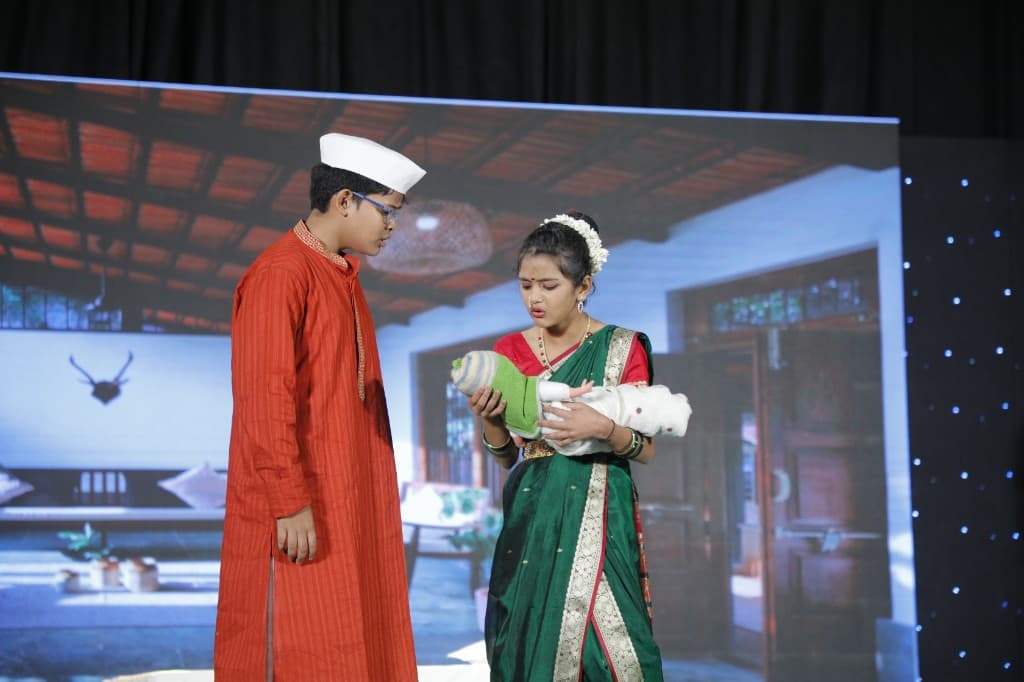 Middle school students performing a family scene on stage