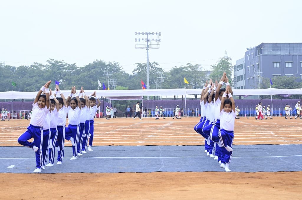 Primary students performing yoga on the sports ground at Lawrence High School