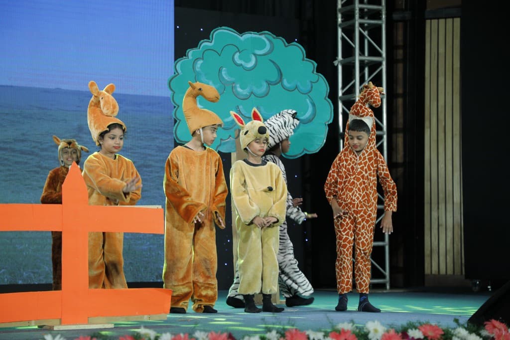 Primary students performing an animal-themed play on stage