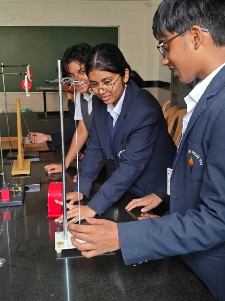 Students working with physics apparatus in the Lawrence High School laboratory