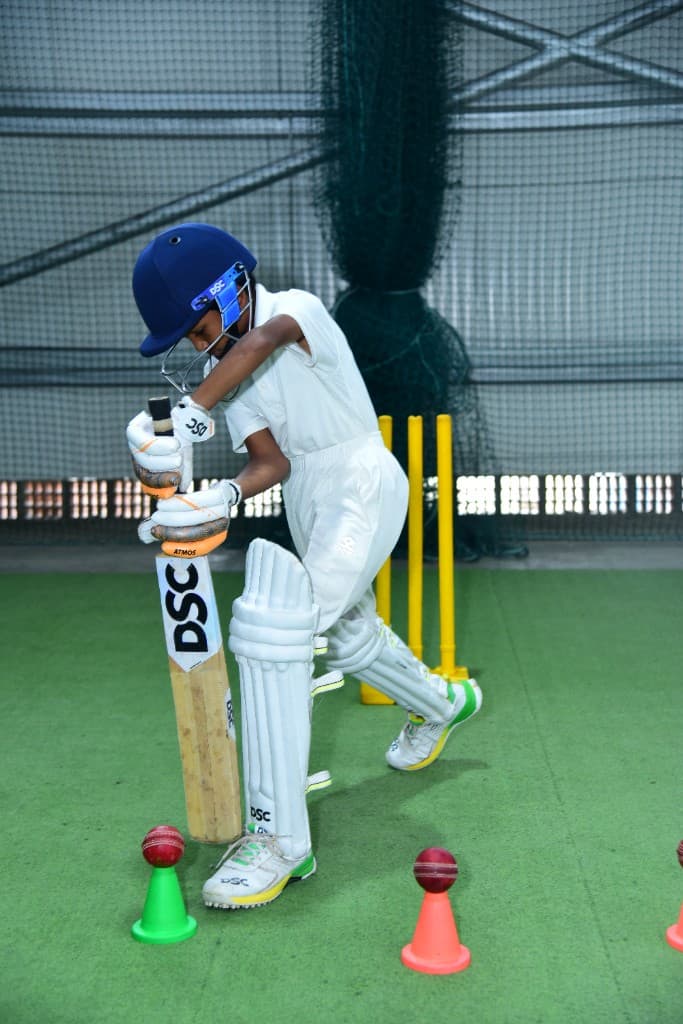 Student batting in the cricket nets at Lawrence High School