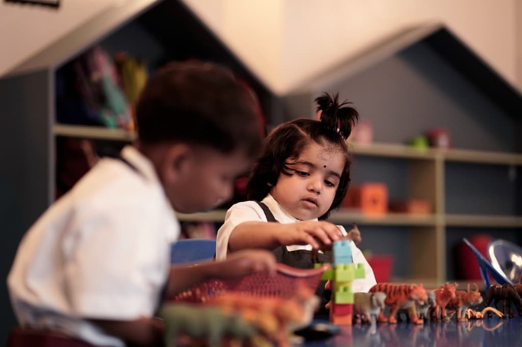 Kindergarten children playing with blocks and toys