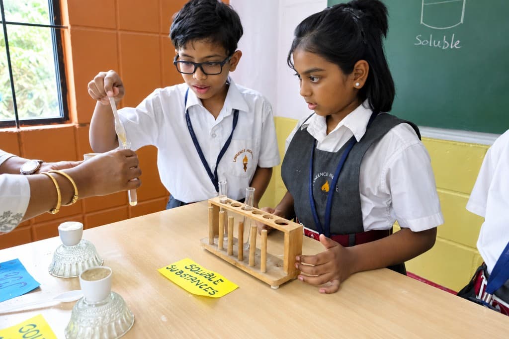 Primary students exploring soluble substances in a science activity at Lawrence High School